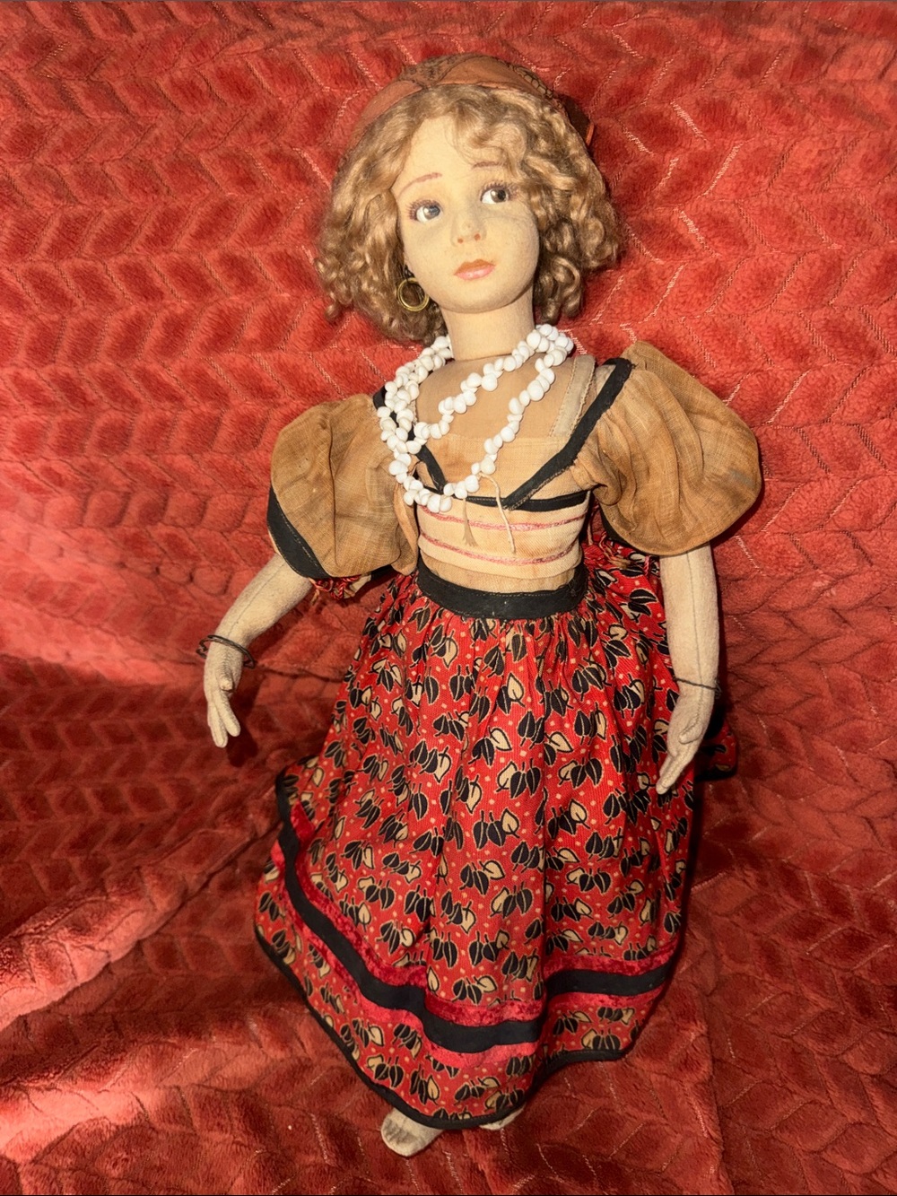 Circa 1920-30 vintage composition and fabric doll with traditional clothing.